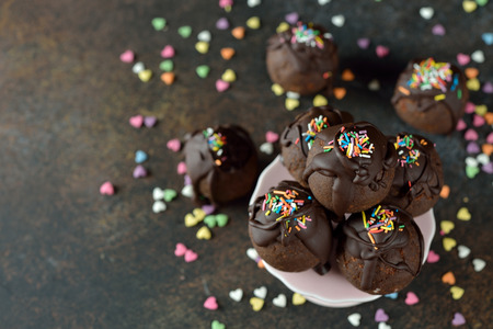 Chocolate truffle cakes on a brown background