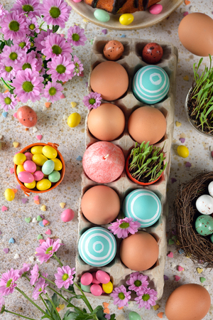 Easter sweets and decorations on a brown background