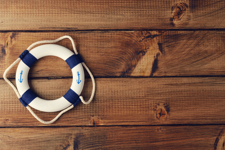 White lifebuoy on a wooden backgroundの写真素材