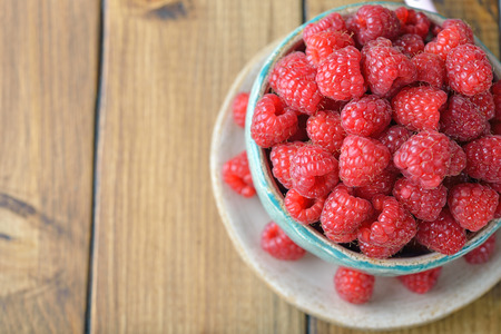 Fresh raspberries on a wooden background