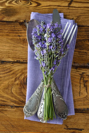 Cutlery, lavender and napkin on a wooden backgroundの写真素材