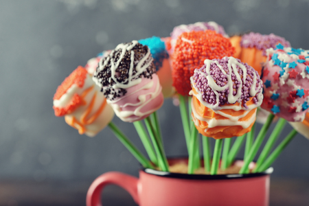 Multicolored marshmallow cake pops on brown backgroundの写真素材