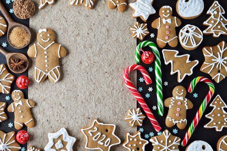 Various Christmas ginger cookies on a brown background