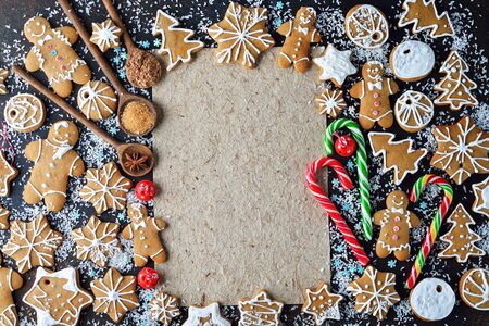 Various Christmas ginger cookies on a brown background