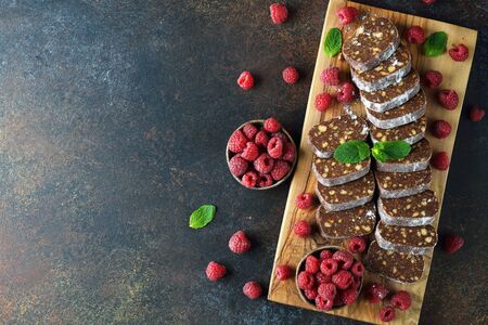 Sweet salami with raspberries on a brown backgroundの写真素材