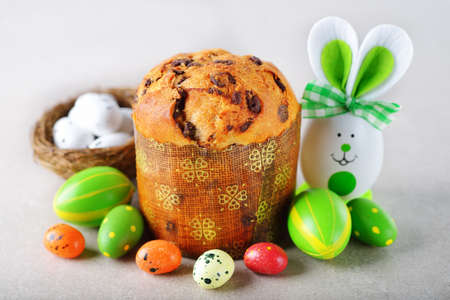 Various Easter decorations and sweets on a gray background