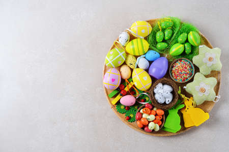 Various Easter decorations and sweets on a gray backgroundの写真素材