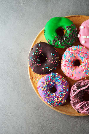 Fresh sweet donuts on gray backgroundの写真素材