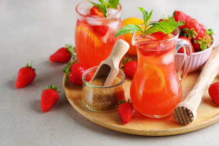 Refreshing summer lemonade with strawberry and lemon on a gray backgroundの写真素材
