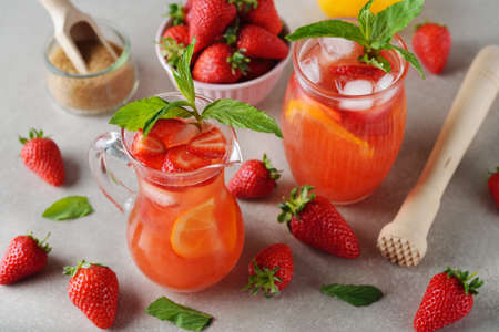 Refreshing summer lemonade with strawberry and lemon on a gray backgroundの写真素材