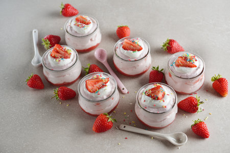 Summer strawberry mousse with whipped cream on a gray backgroundの写真素材