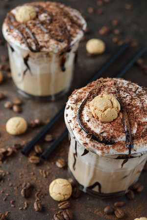 Iced coffee mocha with whipped cream on brown backgroundの写真素材