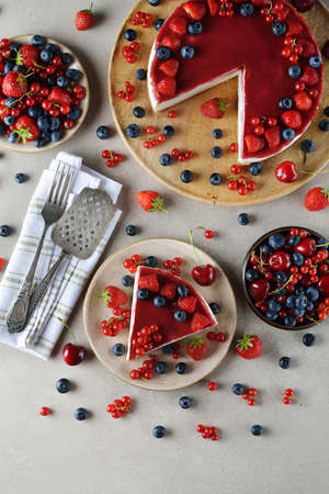 Summer cheesecake with berries on a gray background