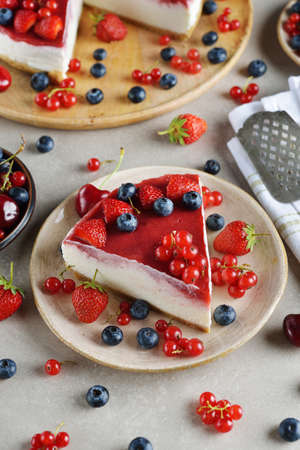 Summer cheesecake with berries on a gray backgroundの写真素材