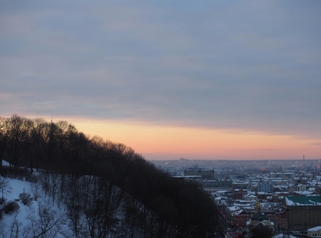 Kiev city with amazing orange yellow red sunset over grand city, Ukraine. Good city under the snow. Winter time, evening.の写真素材