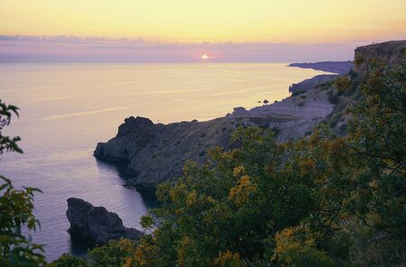 Fiolent, Sevastopol, Crimea, Russia. Sunset time over Black sea. Yellow, purple, lilac colors.の写真素材