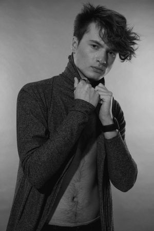 Man portrait. Beautiful young guy, naked nude torso with navel, long forelock, quiff. Black and white handsome male portraitの写真素材