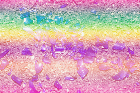 Fragments of colorful glass lie on the asphalt. Photo colors: blue, yellow, lilac, purple, purple. Broken bottle.の写真素材