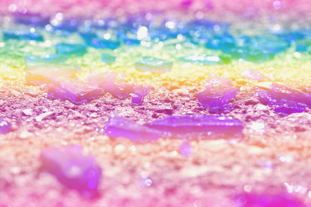Fragments of colorful glass lie on the asphalt. Photo colors: blue, yellow, lilac, purple, purple. Broken bottle.の写真素材