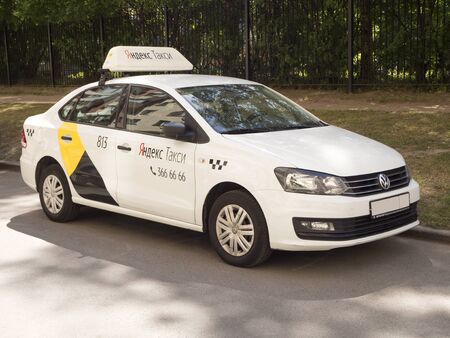 06.20.2019. Saint-Petersburg, Russia. White Yandex taxi car on the street. Yandex.Taxi is an online ride-sharing service launched in 2011 by Yandex (NASDAQ: YNDX), a technology company that builds intelligent products and services powered by machine learnのeditorial素材