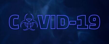 COVID-19 blue neon glowing text with biohazard warning sign instead of the letter O on smokey background. Worldwide 2019 Novel Coronavirus (2019-nCoV) outbreak concept.の写真素材
