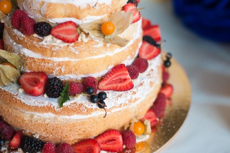 Sweet cake with strawberries on plate on grey wooden backgroundの写真素材