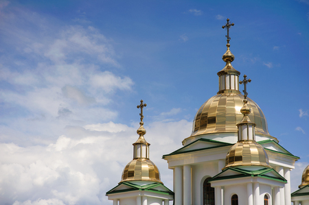 Domes of orthodox church on a background of blue sky and cloudsの写真素材