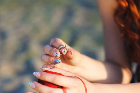 Man making proposal with the ring to his girlfriend. Put ring on hand.の写真素材