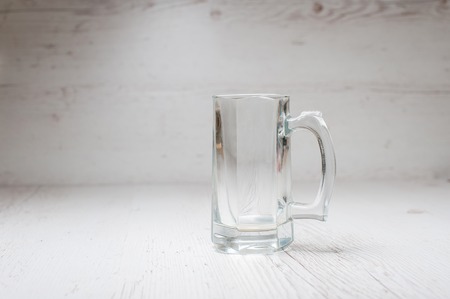 Empty Beer Mug on a light wooden backgroundの写真素材