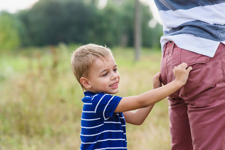 Child playing with his father. Daddy playing active games with his son outside.の写真素材