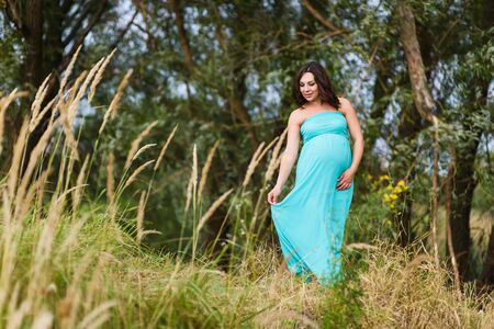 Beautiful pregnant woman outdoorsの写真素材
