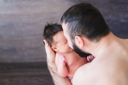 Happy father holding a baby boyの写真素材