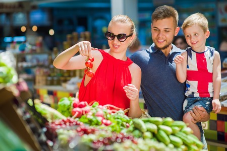 Happy family buys vegetablesの写真素材