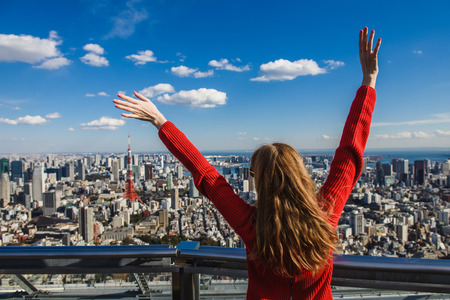 Happy young woman with her hands up.の写真素材