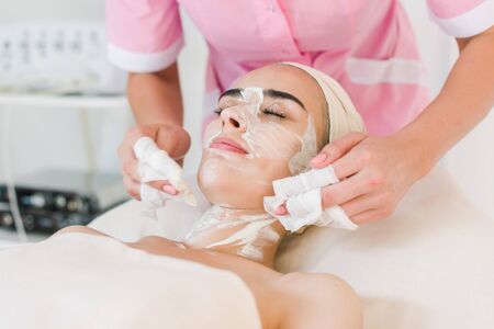 Facial mask removing at beauty salon. Spa beauty organic facial mask.の写真素材