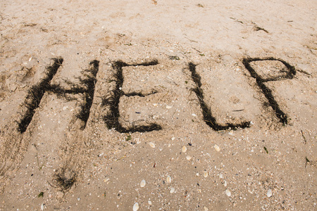 Inscription HELP on a beachの写真素材