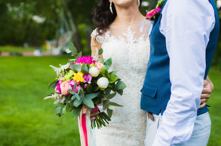 bouquet with peonies and roses in bride handsの写真素材