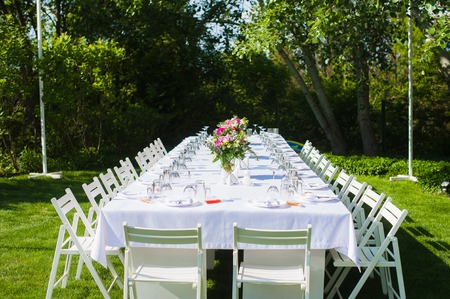 White and long art wedding table outdoors