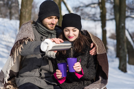 Romantic couple dating in the winter forestの写真素材