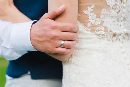 Close-up and details of hands of sensual just married coupleの写真素材