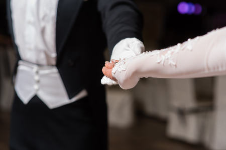 Couple hands dancing waltz at ballの写真素材