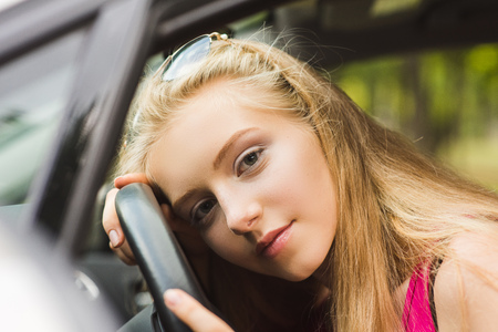 Girl head on steering wheel inside car