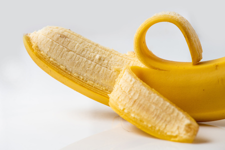 Close-up of fresh open banana on a white backgroundの写真素材