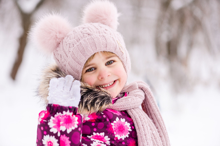 Portrait of cute toddler girl in pink in winterの写真素材