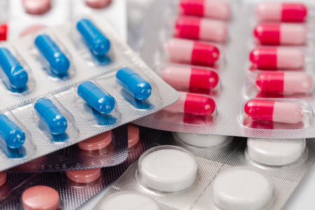 Medicine pills or capsules on white background.