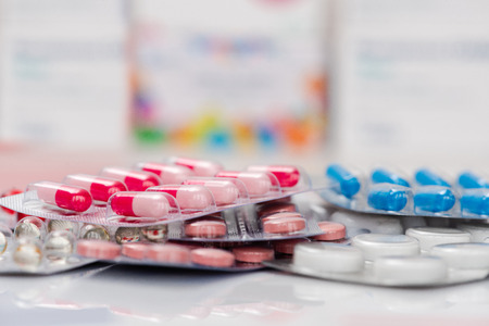 Medicine pills or capsules on white background.