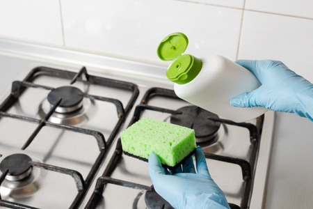 Pour washing detergent from bottle to green spongeの写真素材