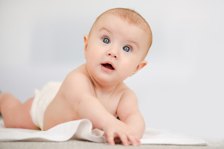 Smiling child with blue eyes on white backgroundの写真素材