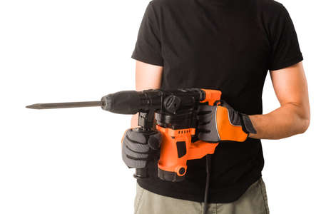 Male hands in protective gloves holding new big electric perforator with long drill and handle at isolated white backgroundの写真素材