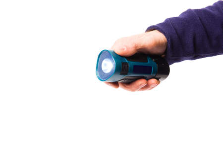 Portable flashlight in a man's hand on a white backgroundの写真素材